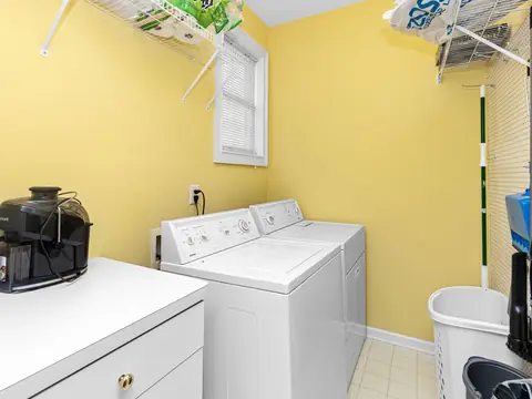 A sunny laundry room with a washer and a dryer