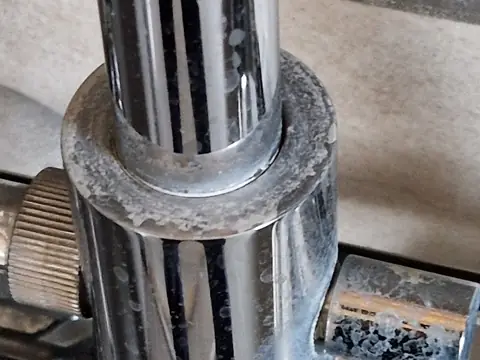 White limescale marks on a chrome tap