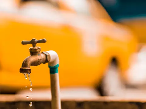 Water dripping from a brass outdoor tap