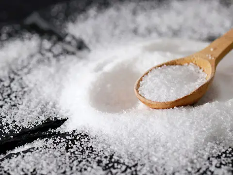 Fine white salt in a wooden spoon