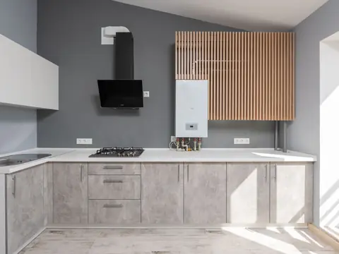 A bright kitchen with a wall-mounted water heater