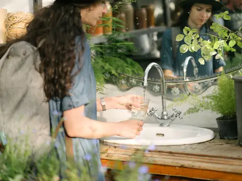 Filling a glass at an outdoor sink