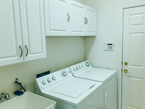 A laundry room with a washer, a dryer and a utility sink